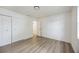 Bedroom with wood-look floors, double closet and ensuite bathroom access at 624 Fort Duquesna Dr, Sun City Center, FL 33573