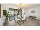 Stylish dining room featuring glass top table, modern lighting, and wood flooring at 624 Fort Duquesna Dr, Sun City Center, FL 33573