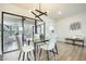Light and airy dining area with a glass table, modern lighting, and sleek white chairs at 624 Fort Duquesna Dr, Sun City Center, FL 33573