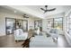 Airy living room featuring modern furnishings, stylish decor, wood flooring, and views to the dining and bedroom areas at 624 Fort Duquesna Dr, Sun City Center, FL 33573