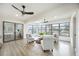Comfortable sunroom with bright furniture, large windows, and ceiling fans at 624 Fort Duquesna Dr, Sun City Center, FL 33573