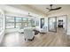 Inviting sunroom featuring plush seating, large windows, and modern ceiling fans at 624 Fort Duquesna Dr, Sun City Center, FL 33573