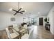Open concept living and dining area, showcasing a glass table and contemporary lighting at 624 Fort Duquesna Dr, Sun City Center, FL 33573