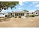 Rear view of a home with a screened patio, complemented by tidy landscaping and ample outdoor space at 624 Fort Duquesna Dr, Sun City Center, FL 33573
