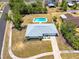 Aerial shot reveals a home with a private backyard pool, mature trees, and a well-manicured lawn, showcasing its outdoor amenities at 6698 Acmar Ct, North Port, FL 34287