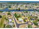 Aerial view of a home with a private pool near a canal, surrounded by lush landscaping and neighborhood homes at 6698 Acmar Ct, North Port, FL 34287