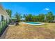 Charming backyard with a pool, patio dining set, and barbecue grill, perfect for enjoying outdoor meals and gatherings at 6698 Acmar Ct, North Port, FL 34287