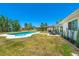 A spacious backyard features a patio with seating near the pool, blending relaxation and recreation at 6698 Acmar Ct, North Port, FL 34287