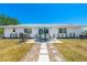 A backyard oasis with a patio, grill, and manicured lawn provides a perfect outdoor retreat at 6698 Acmar Ct, North Port, FL 34287