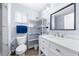 Charming bathroom with a toilet, a vanity and a storage rack for bathroom essentials at 6698 Acmar Ct, North Port, FL 34287