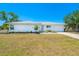 Charming single-level house showcases a neatly landscaped front yard, freshly painted exterior, and a welcoming front entrance at 6698 Acmar Ct, North Port, FL 34287