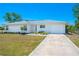 Attractive home featuring a manicured front lawn, an attached garage and an easily accessible concrete driveway at 6698 Acmar Ct, North Port, FL 34287