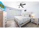 Bright bedroom with a large bed, wood-look flooring, and neutral decor at 6698 Acmar Ct, North Port, FL 34287