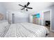 Spacious main bedroom boasts a ceiling fan, ensuite bath and walk in closet, and neutral paint at 6698 Acmar Ct, North Port, FL 34287
