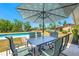 Enjoy outdoor dining on the covered patio with a stylish table set and backyard pool at 6698 Acmar Ct, North Port, FL 34287