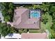 Overhead shot of a house featuring a tile roof, screened pool, and well-maintained landscaping at 6924 Cumberland Ter, Bradenton, FL 34201