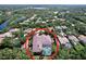 An aerial view of the property showcasing the screened pool and the surrounding lush, green neighborhood at 6924 Cumberland Ter, University Park, FL 34201
