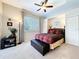 Cozy bedroom with large window, a ceiling fan, and carpeted floors at 6924 Cumberland Ter, Bradenton, FL 34201