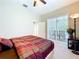 Bedroom with a sliding glass door that provides access to a screened in lanai at 6924 Cumberland Ter, Bradenton, FL 34201