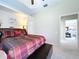 Neutral bedroom featuring a ceiling fan and an open view to the living room at 6924 Cumberland Ter, Bradenton, FL 34201