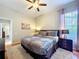 This bedroom features a plush rug, ceiling fan, and a window at 6924 Cumberland Ter, Bradenton, FL 34201