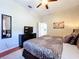Bedroom with ceiling fan, TV, king bed, and soft carpet, creating a relaxing atmosphere at 6924 Cumberland Ter, University Park, FL 34201