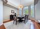 A light-filled dining area featuring a large bay window and elegant decor at 6924 Cumberland Ter, University Park, FL 34201
