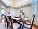Dining room showing dining table set for a meal and decorative lighting at 6924 Cumberland Ter, University Park, FL 34201
