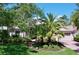 Well-manicured home featuring a brick driveway and walkway, lush green lawn, and mature landscaping at 6924 Cumberland Ter, Bradenton, FL 34201