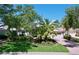 Beautifully landscaped home featuring a brick driveway, lush greenery, and a well-maintained lawn at 6924 Cumberland Ter, Bradenton, FL 34201