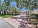 Charming single-story home with mature landscaping, a brick driveway, and an attached two-car garage at 6924 Cumberland Ter, University Park, FL 34201