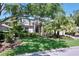 Charming home with mature trees, lush landscaping, and a well-manicured lawn at 6924 Cumberland Ter, University Park, FL 34201