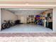 Spacious two-car garage with ample storage space and a door to the home's interior at 6924 Cumberland Ter, University Park, FL 34201