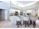 An open kitchen with granite counters, stainless steel appliances, and bar stool seating at 6924 Cumberland Ter, University Park, FL 34201