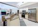 A gourmet kitchen with stainless steel appliances and open access to living area at 6924 Cumberland Ter, University Park, FL 34201