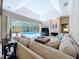 Living room with skylight, fireplace, sliding glass doors to patio and pool, and comfortable furnishings at 6924 Cumberland Ter, University Park, FL 34201