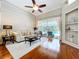 Bright living room with hardwood flooring and a sliding door leading to a pool and outdoor space at 6924 Cumberland Ter, Bradenton, FL 34201
