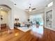 Inviting living room with hardwood floors, comfortable seating, and seamless access to the lanai and pool area at 6924 Cumberland Ter, University Park, FL 34201