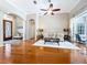 Spacious living room with hardwood floors, comfortable seating, and views of the front entrance and screened lanai at 6924 Cumberland Ter, University Park, FL 34201
