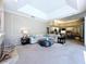 Bright open-concept living area with views to the kitchen, neutral walls, and comfortable furnishings at 6924 Cumberland Ter, University Park, FL 34201