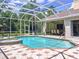 Backyard pool with a screened lanai and surrounding lush greenery at 6924 Cumberland Ter, University Park, FL 34201