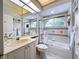 Well-lit secondary bathroom features a tub-shower combo, decorative mirror and vanity with storage at 6924 Cumberland Ter, University Park, FL 34201