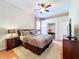 Comfortable bedroom features a ceiling fan, plush rug, and double closets for ample storage space at 6924 Cumberland Ter, University Park, FL 34201