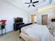 Well-lit bedroom with tray ceilings featuring a television, closet and bathroom access for convenience at 6924 Cumberland Ter, University Park, FL 34201