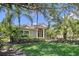 Beautiful home exterior featuring a well-manicured lawn and lush tropical landscaping at 6924 Cumberland Ter, University Park, FL 34201