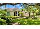Charming single-story home with a tile roof, lush landscaping, and a well-manicured lawn, offering great curb appeal at 6924 Cumberland Ter, University Park, FL 34201
