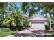 Inviting home featuring a manicured front yard, brick driveway, and an attached two-car garage at 6924 Cumberland Ter, University Park, FL 34201