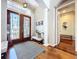 Inviting foyer features a decorative glass door, hardwood floors, and a bench at 6924 Cumberland Ter, University Park, FL 34201