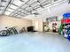 Spacious garage with ample storage, epoxy flooring, and space for vehicles and equipment at 6924 Cumberland Ter, University Park, FL 34201