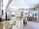 Open-concept kitchen featuring granite countertops, white cabinetry, and a breakfast bar at 6924 Cumberland Ter, University Park, FL 34201